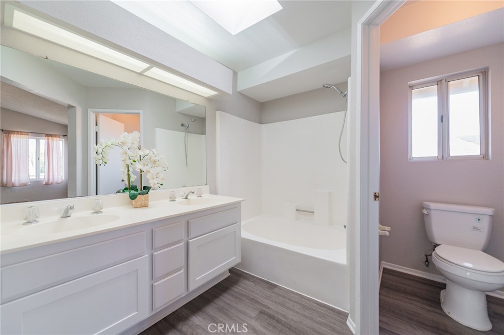 1955 Sierra Espadan Road Perris, CA 92571 - Photo 22 of 29 a bathroom with a double vanity sink toilet mirror and bathtub