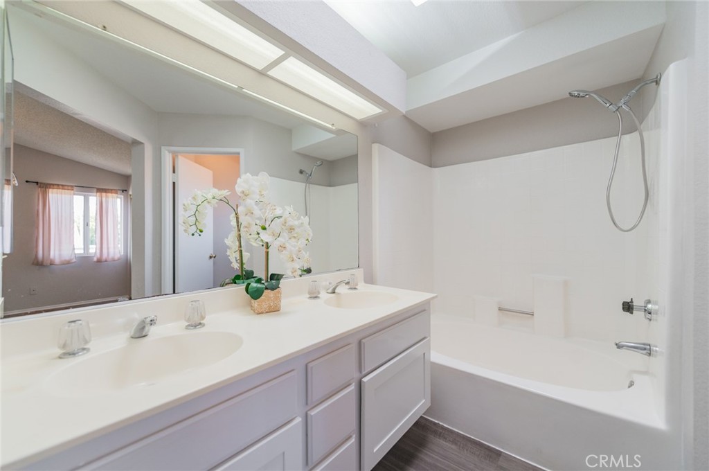 1955 Sierra Espadan Road Perris, CA 92571 - Photo 23 of 29 a bathroom with a double vanity sink bathtub and shower