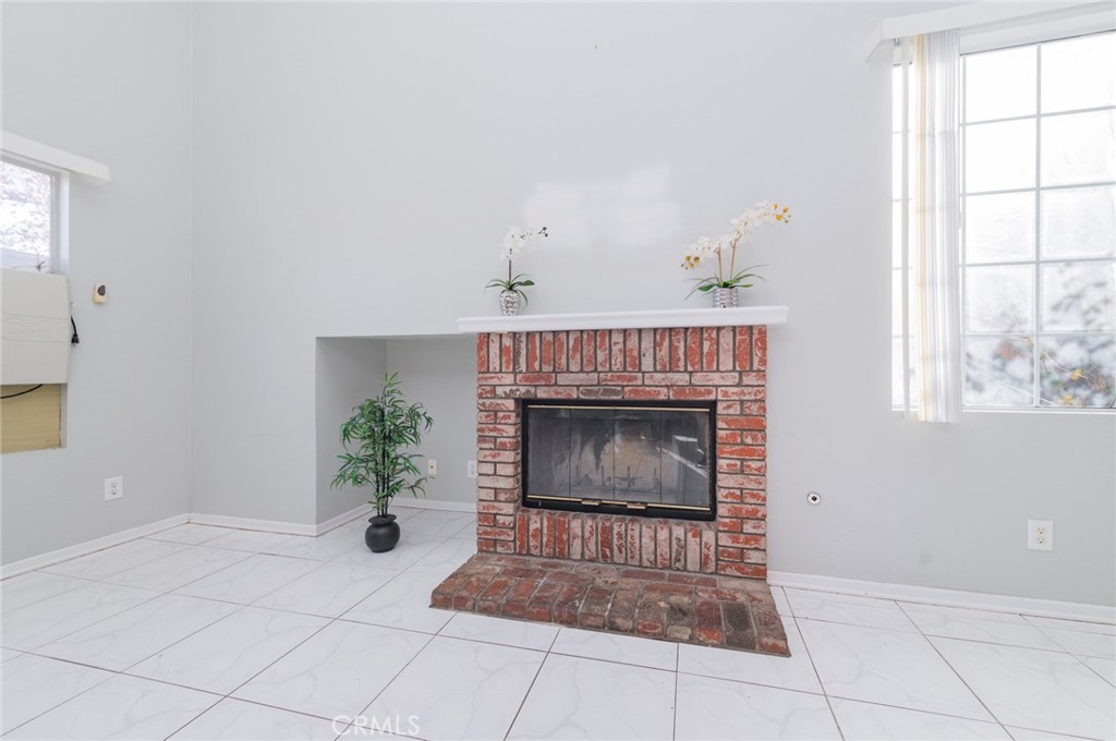 1955 Sierra Espadan Road Perris, CA 92571 - Photo 4 of 29 a living room with furniture and a fireplace