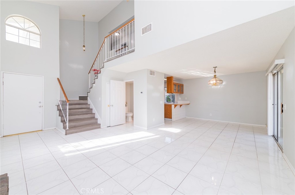1955 Sierra Espadan Road Perris, CA 92571 - Photo 5 of 29 a view of a livingroom with wooden floor and stairs