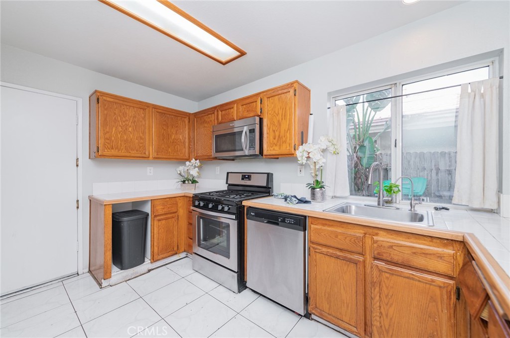 1955 Sierra Espadan Road Perris, CA 92571 - Photo 10 of 29 a kitchen with stainless steel appliances granite countertop a stove sink and cabinets