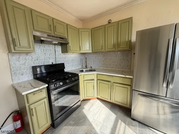 a kitchen with a refrigerator sink and stove