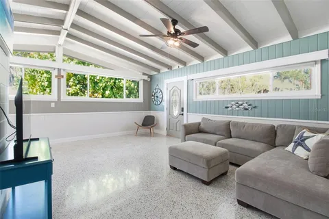 a dining room with furniture a window and a chandelier