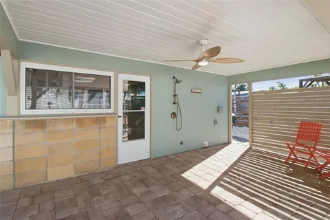 a view of a patio with a table and chairs and couches