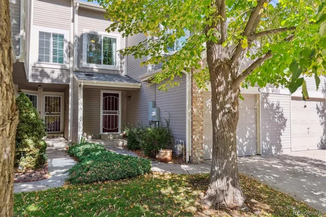 a brick house with a tree in front of it