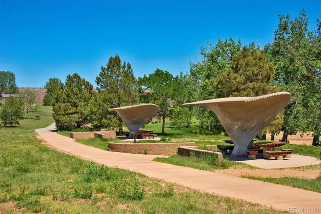 a view of outdoor space with seating area and trees around