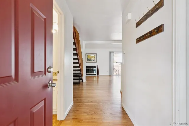 a view of a hallway with wooden floor and entryway