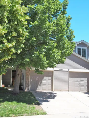 front view of a house with a tree