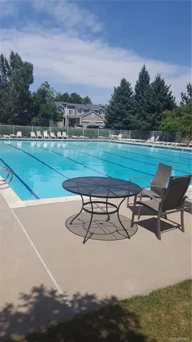 a view of a swimming pool and lounge chairs
