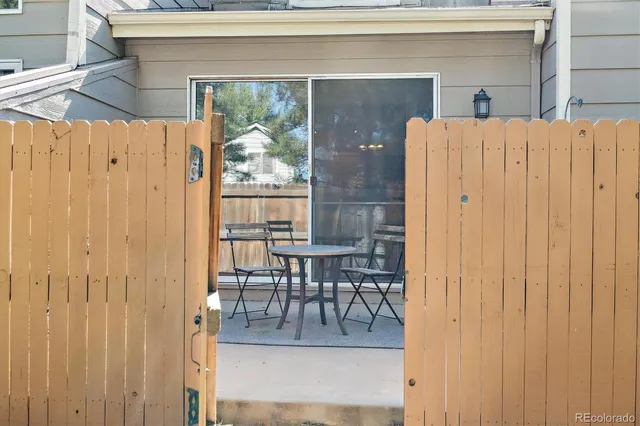 a view of a patio with table and chairs
