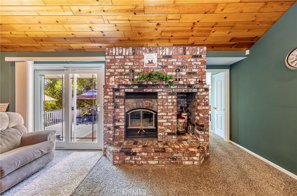 41715 River Falls Road Oakhurst, CA 93644 - Photo 16 of 65 a living room with a couch and a fireplace