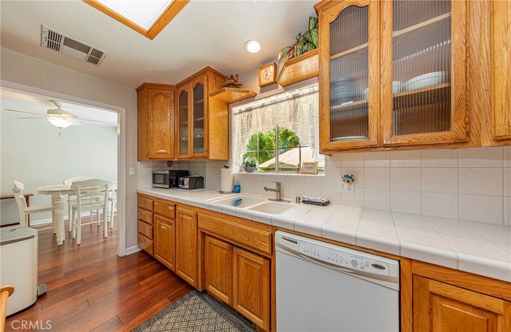 41715 River Falls Road Oakhurst, CA 93644 - Photo 23 of 65 a kitchen with stainless steel appliances granite countertop a sink a stove cabinets counter space and a window