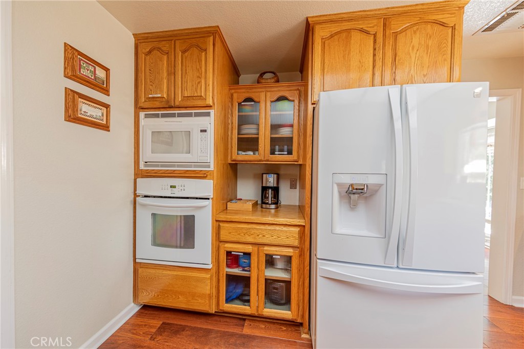 41715 River Falls Road Oakhurst, CA 93644 - Photo 27 of 65 a kitchen with stainless steel appliances granite countertop a refrigerator and a stove