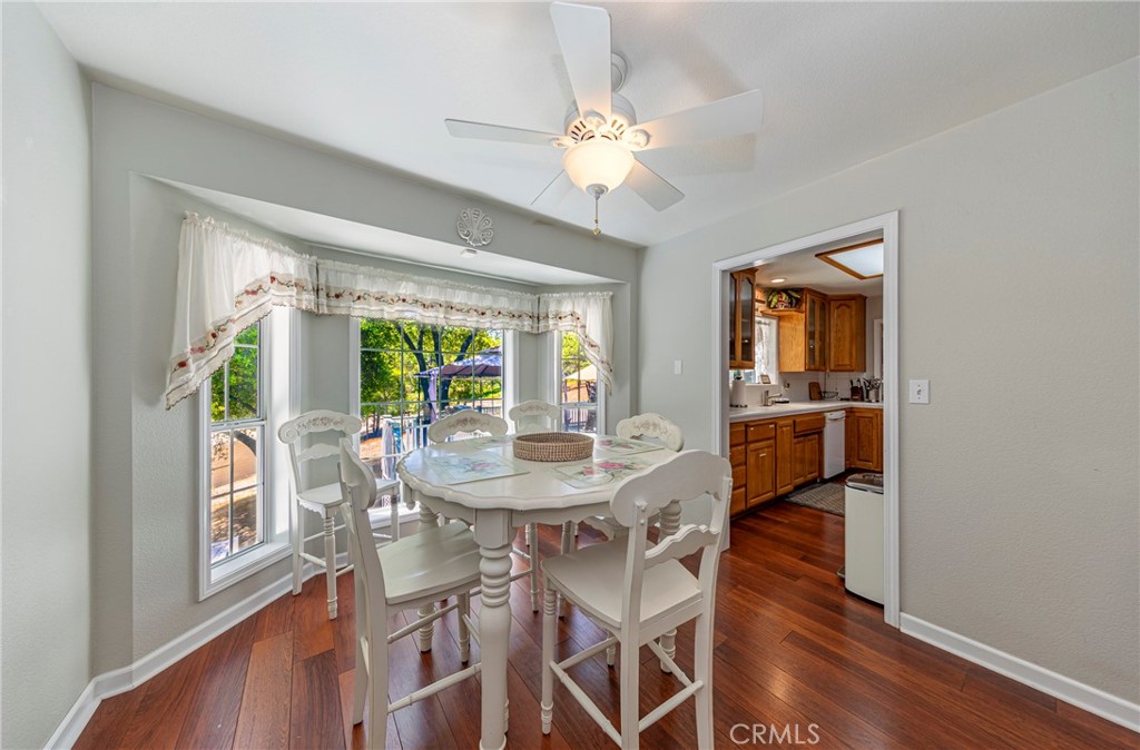 41715 River Falls Road Oakhurst, CA 93644 - Photo 29 of 65 a view of a dining room with furniture window and wooden floor