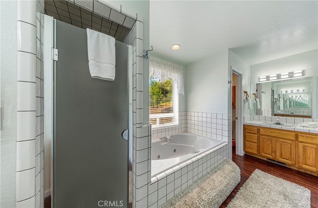 41715 River Falls Road Oakhurst, CA 93644 - Photo 38 of 65 a bathroom with a bathtub and a shower
