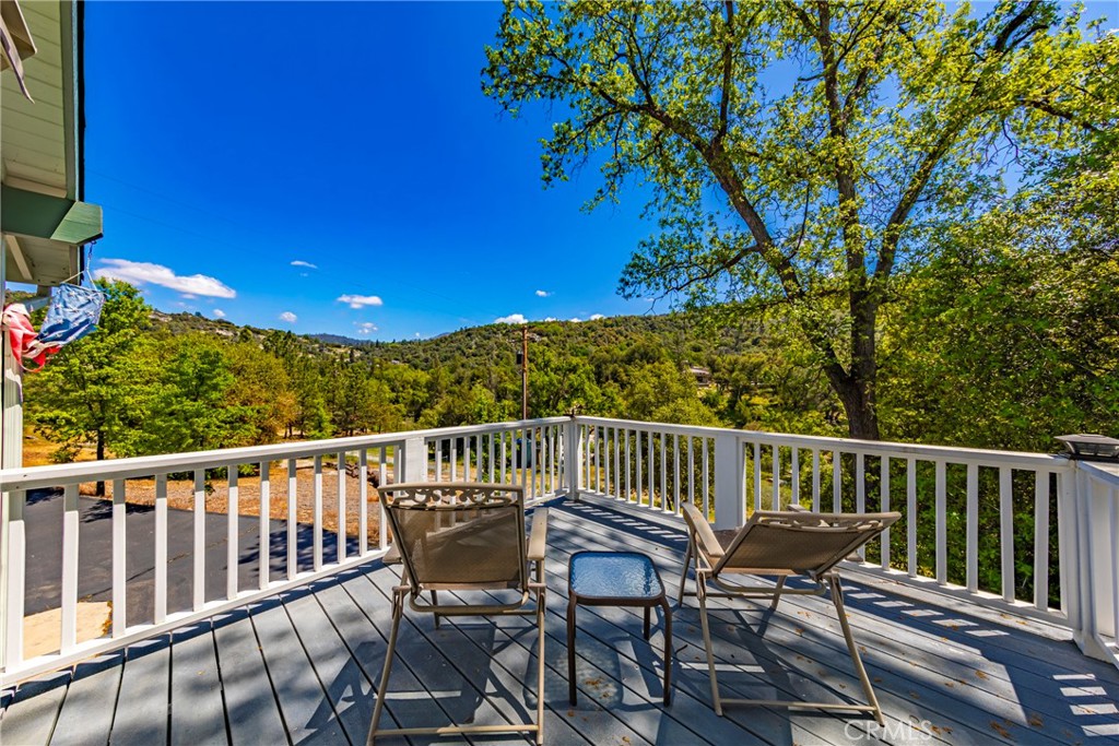 41715 River Falls Road Oakhurst, CA 93644 - Photo 48 of 65 a view of a chair and table in the balcony