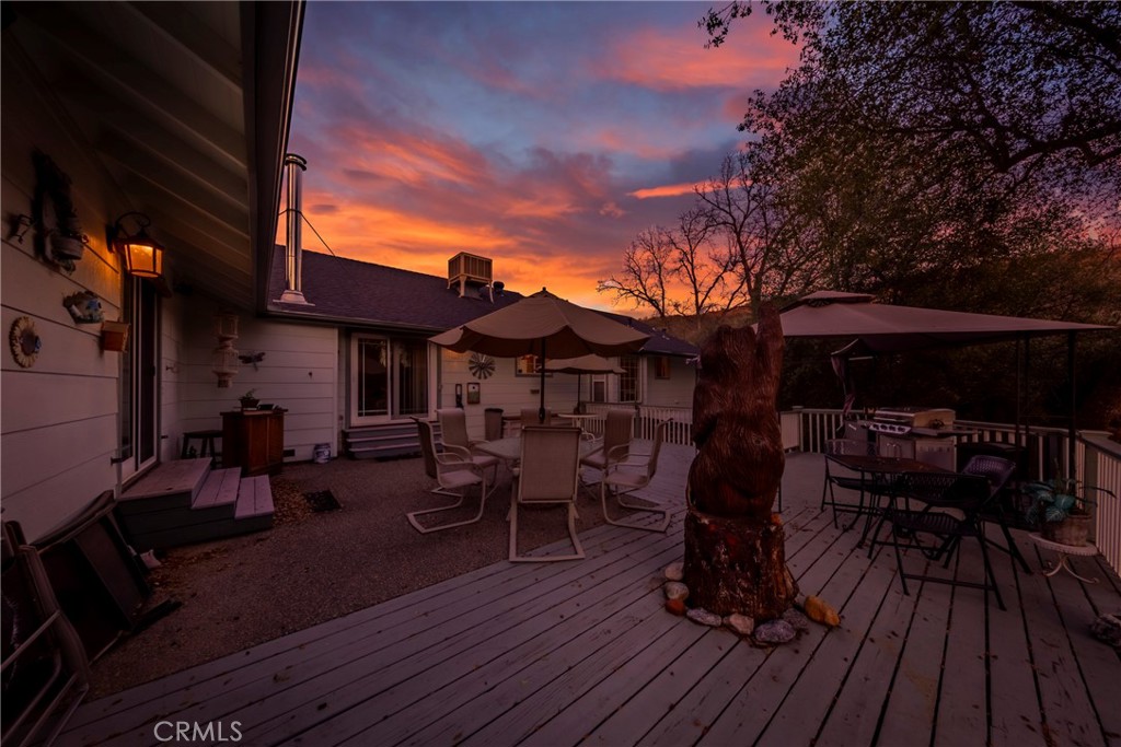41715 River Falls Road Oakhurst, CA 93644 - Photo 60 of 65 a view of a house with wooden deck and furniture