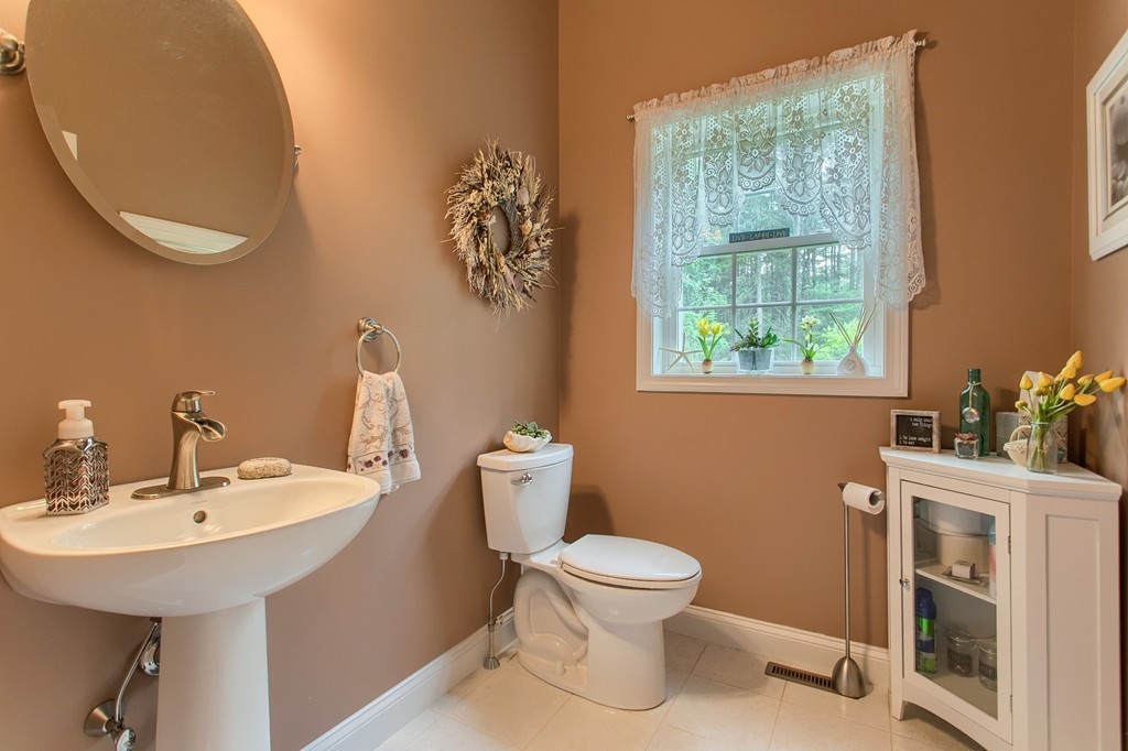 264 Westford Road Tyngsborough, MA 01879 - Photo 12 of 27 a bathroom with a sink mirror and toilet