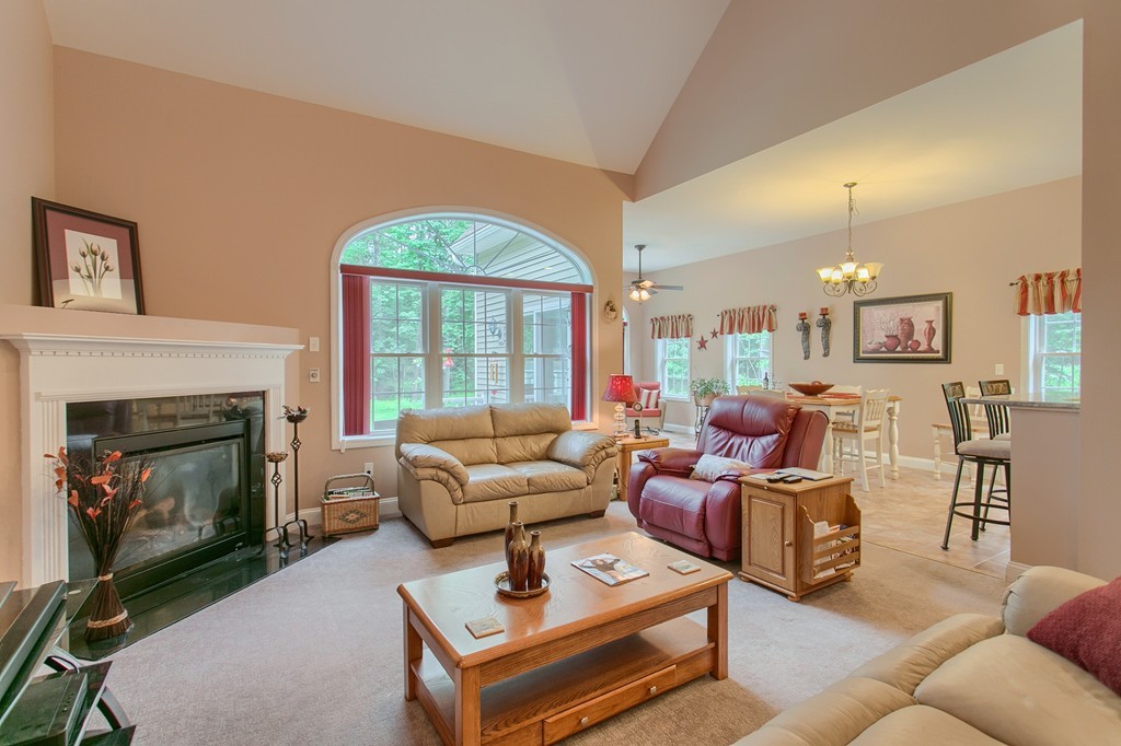 264 Westford Road Tyngsborough, MA 01879 - Photo 2 of 27 a living room with furniture fireplace and a large window
