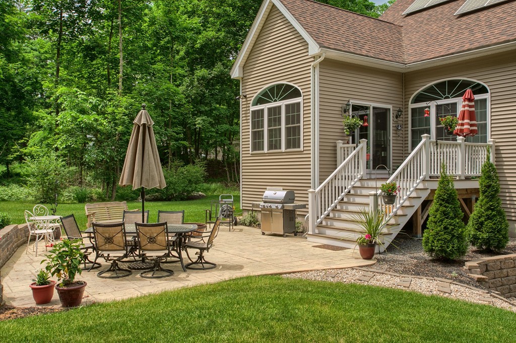 264 Westford Road Tyngsborough, MA 01879 - Photo 25 of 27 a view of a house with backyard sitting area and garden
