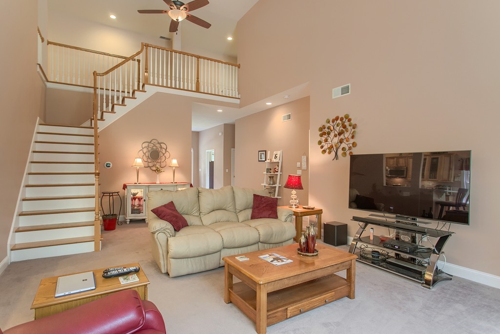 264 Westford Road Tyngsborough, MA 01879 - Photo 3 of 27 a living room with furniture and a flat screen tv