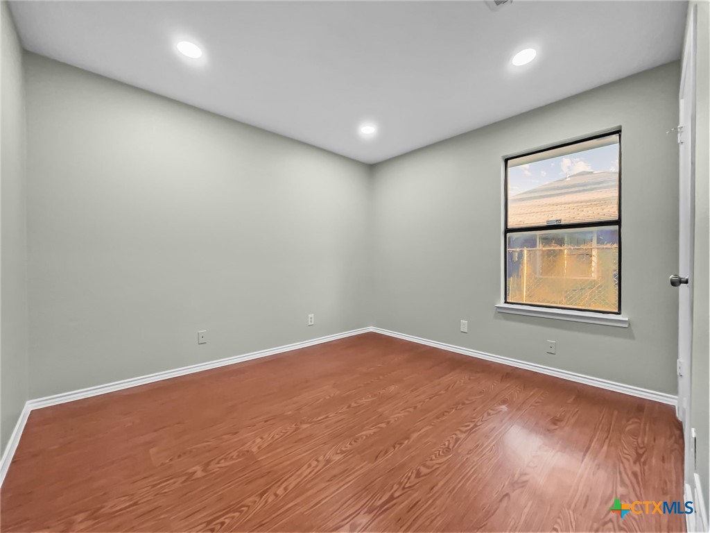 5009 Ridge Haven Drive Killeen, TX 76543 - Photo 12 of 16 an empty room with wooden floor and windows