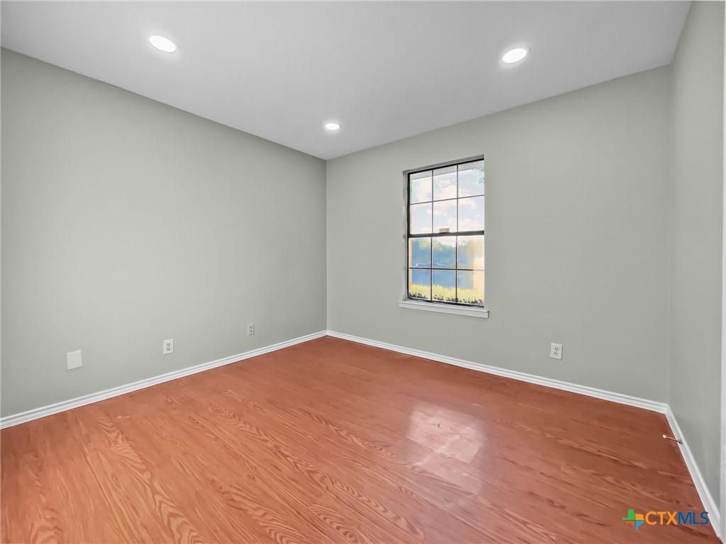 5009 Ridge Haven Drive Killeen, TX 76543 - Photo 13 of 16 a view of an empty room with wooden floor and a window
