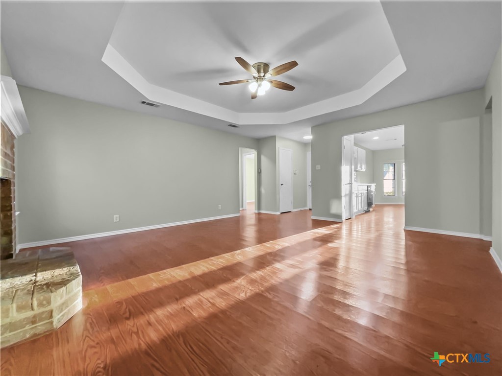 5009 Ridge Haven Drive Killeen, TX 76543 - Photo 3 of 16 a view of an empty room with wooden floor and a ceiling fan