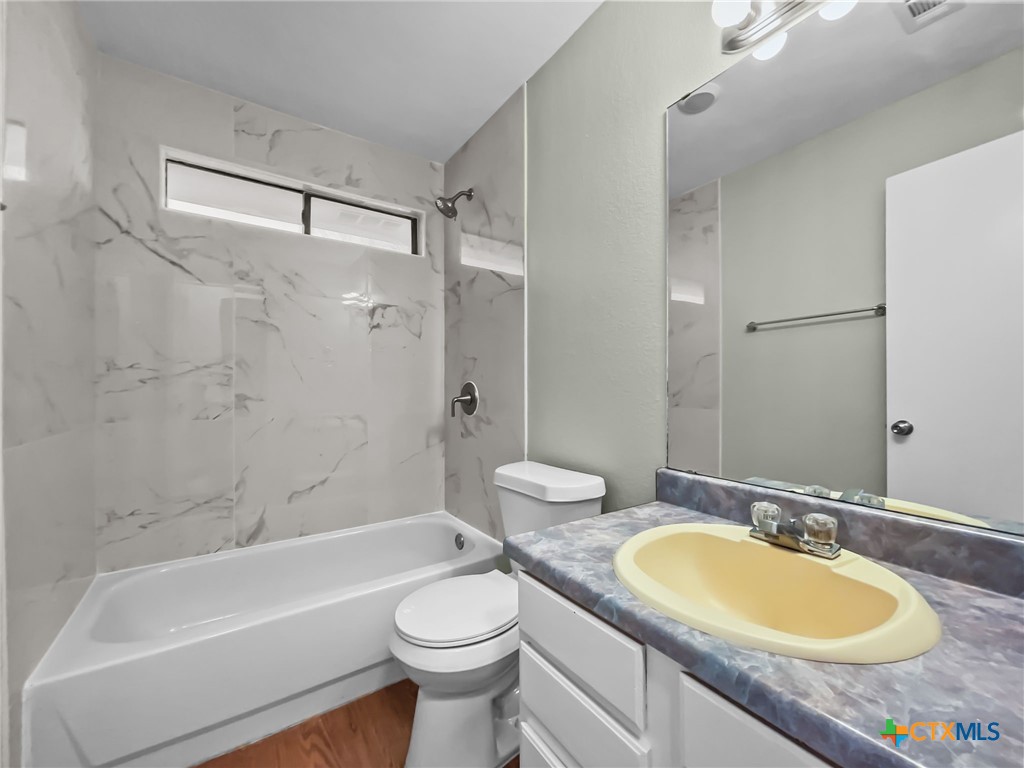 5009 Ridge Haven Drive Killeen, TX 76543 - Photo 6 of 16 a bathroom with a granite countertop sink mirror toilet and bathtub