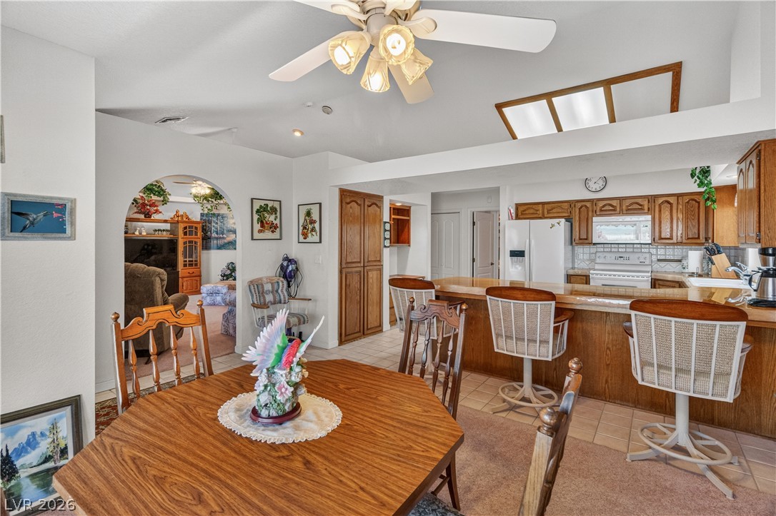 2055 Cholla Way Laughlin, NV 89029 - Photo 19 of 87 A well-lit kitchen with a wood-paneled island offers a cozy dining nook and ample space for culinary endeavors.