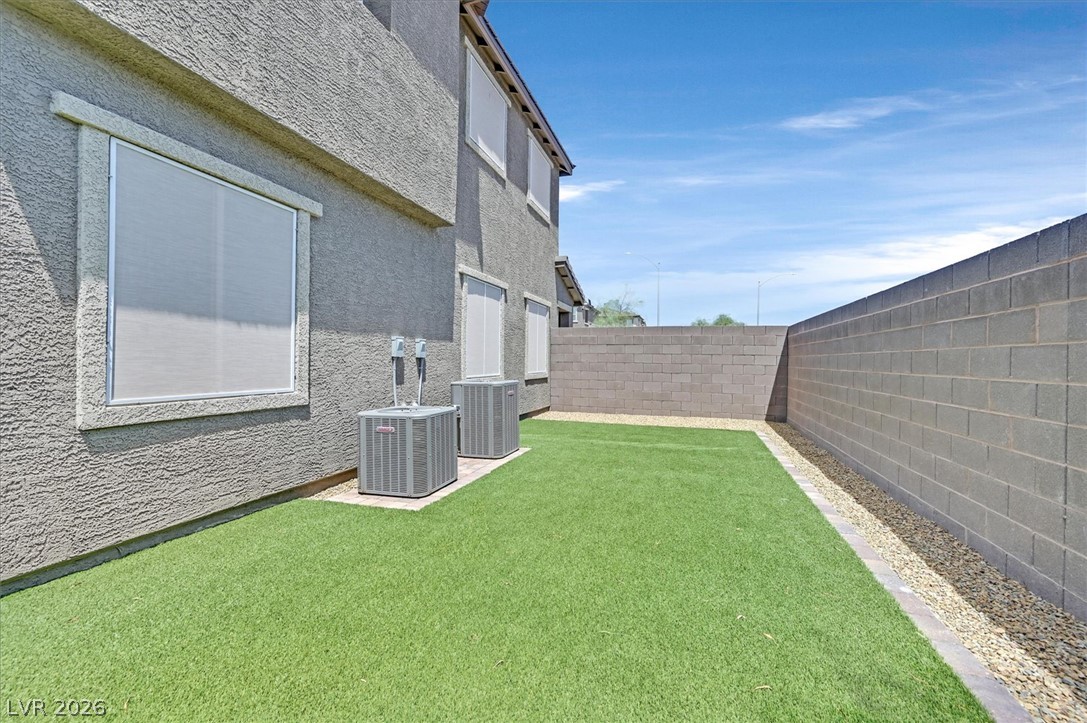 2933 Little Current Road North Las Vegas, NV 89086 - Photo 33 of 35 Secure yard featuring maintenance-free turf, privacy block walls, and ample sun exposure.