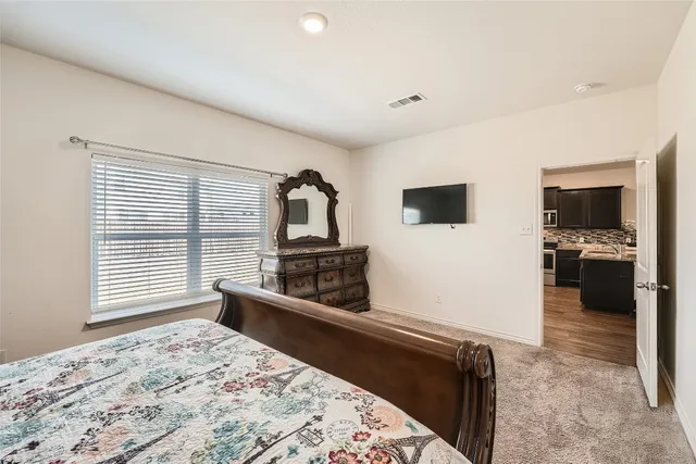 a living room with stainless steel appliances kitchen island granite countertop a refrigerator and a stove top oven
