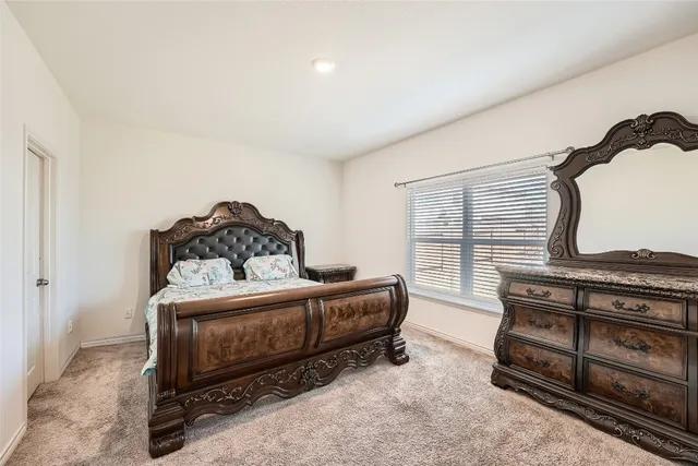 a bedroom with furniture and a window