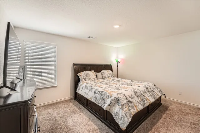 a bedroom with a bed and with windows