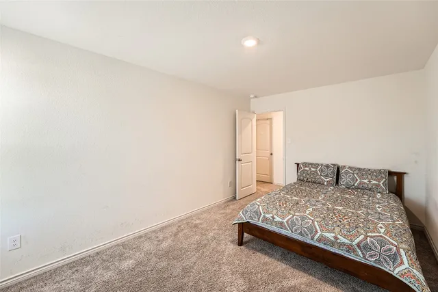 a large bed sitting in a room next to a wall