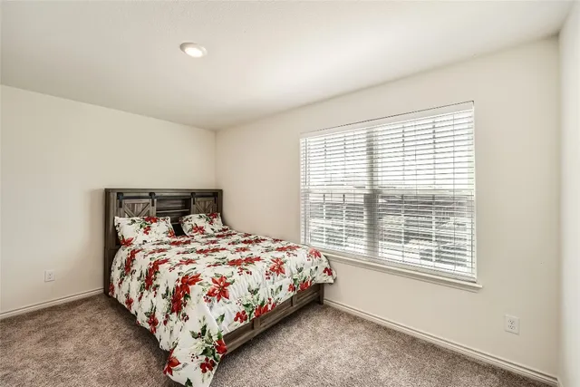 a bedroom with a bed and window