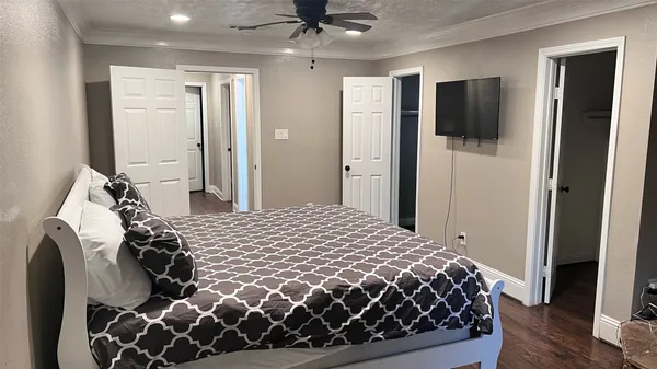 a bedroom with a bed and a flat tv screen