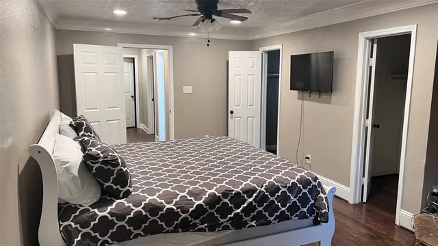 a bedroom with a bed and a flat tv screen