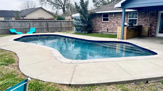 a view of a backyard with swimming pool