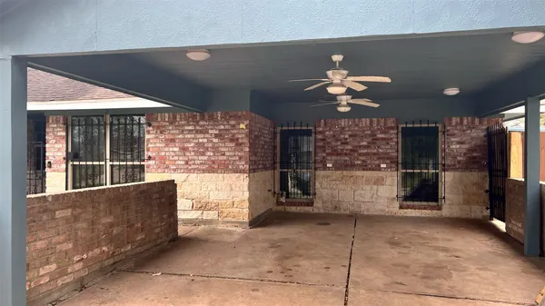 a living room with fireplace furniture and a large window