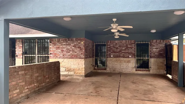 a living room with fireplace furniture and a large window