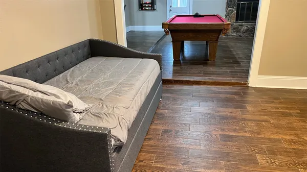 a bedroom with a bed and a mirror