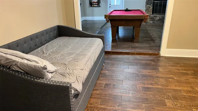 a bedroom with a bed and a mirror