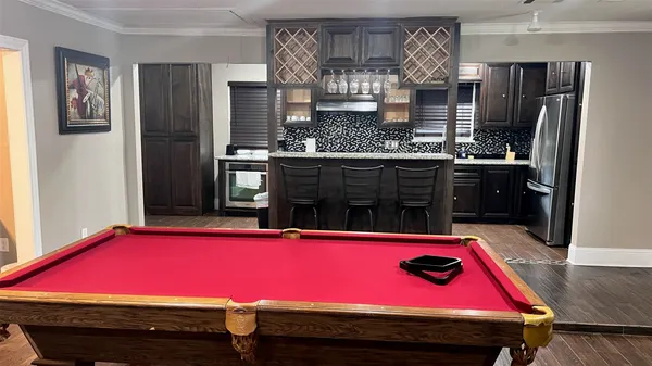 a kitchen with stainless steel appliances kitchen island granite countertop a refrigerator stove and sink