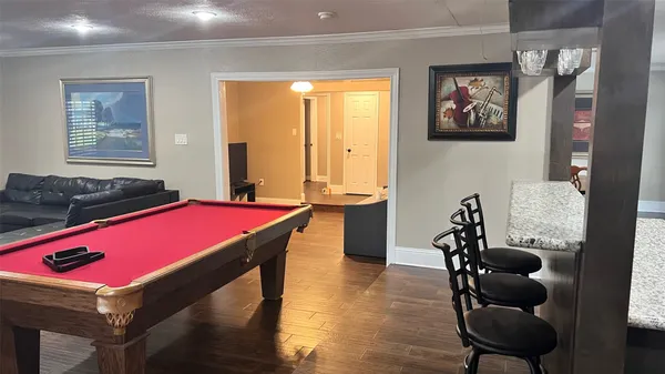 a room with furniture pool table and windows