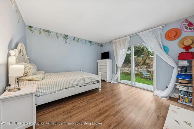 a bedroom with furniture and a book shelf