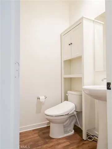 a white toilet sitting next to a bathroom sink