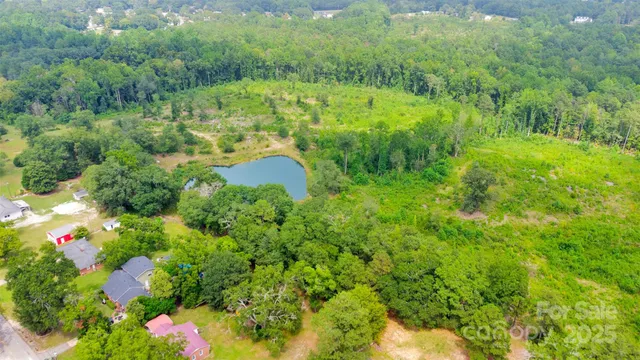 an aerial view of residential house with swimming pool and green space