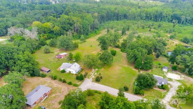 a view of backyard with swimming pool