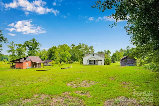 a backyard of a house with lots of green space and garden area